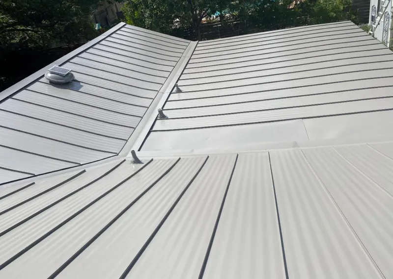 Solar attic fan installed on a metal roof for Roof Ventilation in Golden Gate